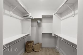Large walk-in closet with empty shelves